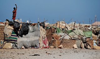 1412863003698_wps_5_A_Somali_boy_stands_on_a_.jpg