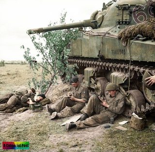 M4A2, Sherman Mk III “Cameo” crew of 2nd Troop, ‘C’ Squadron, 13th-18th Royal Hussars, 27th Armoured Brigade rest and write letters home by the side of their vehicle, Normandy, 10 June 1944.jpg